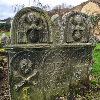 Early 18th century gravstone in Tillicoultry with trade and mortaility symbols